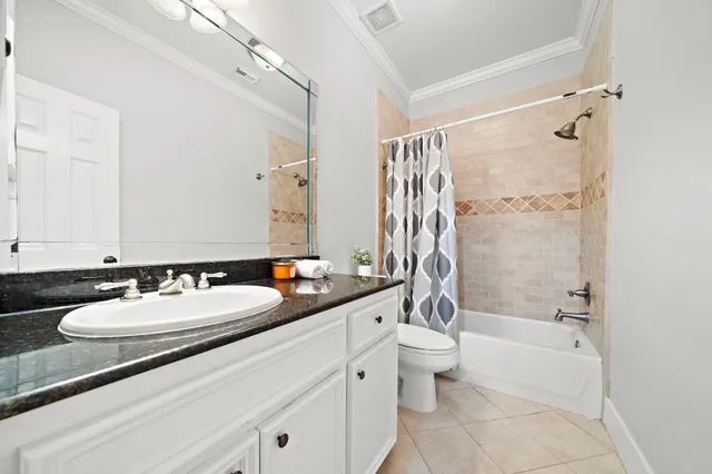 a bathroom with a double vanity sink toilet mirror and shower