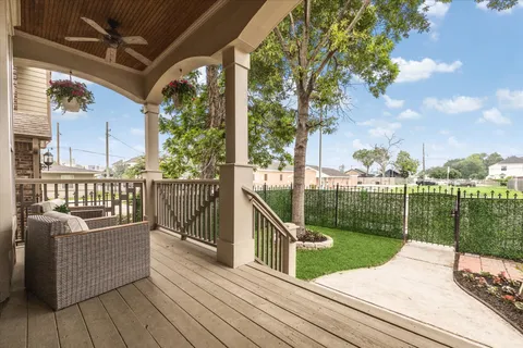 a view of a deck with couches and wooden floor with a yard