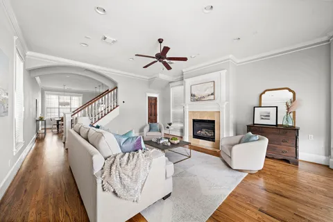 a living room with furniture fireplace and wooden floor