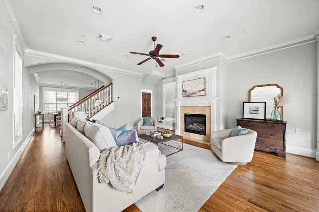 a living room with furniture fireplace and wooden floor