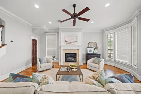 a living room with furniture a fireplace and a large window