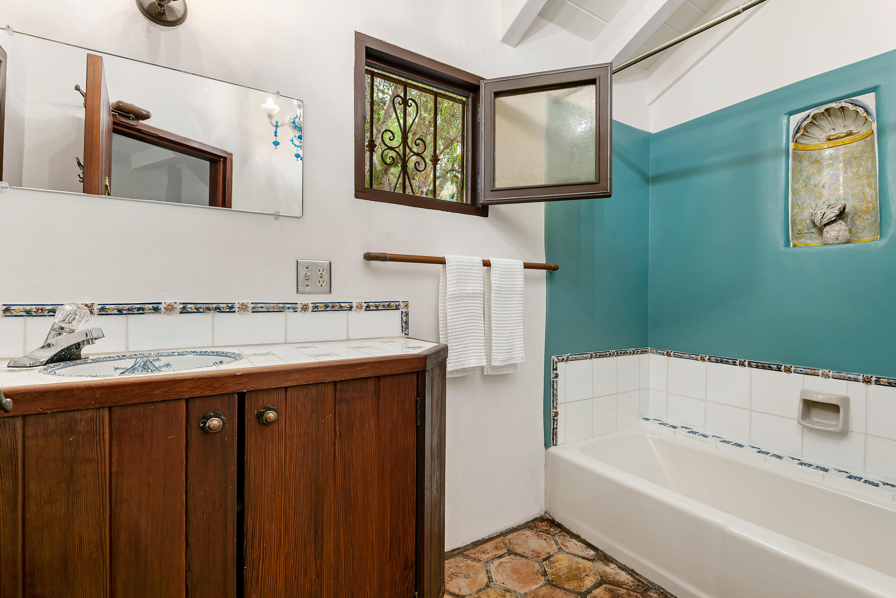2217 Mission Ridge Road Santa Barbara, CA 93103 - Photo 33 of 57 a bathroom with a granite countertop sink a mirror a toilet and bathtub