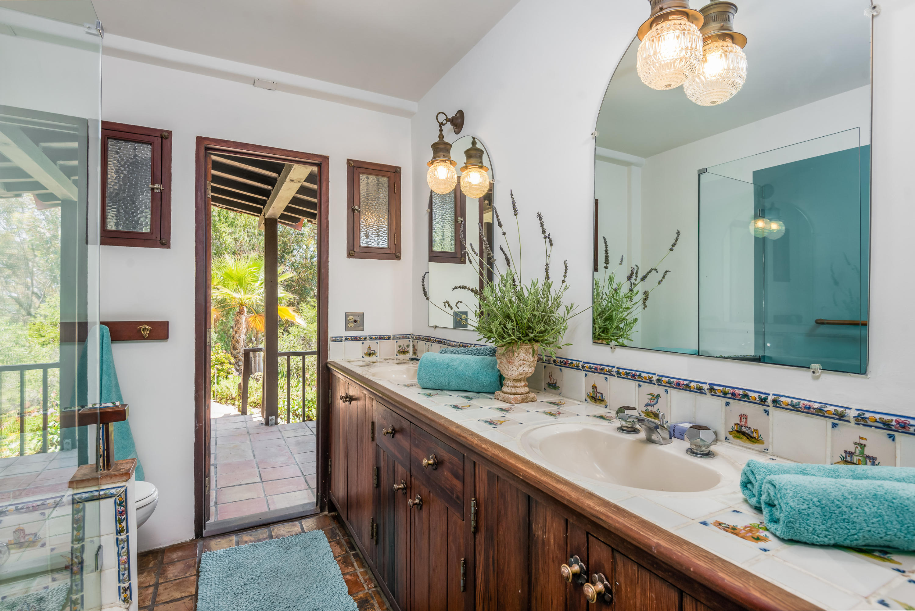 2217 Mission Ridge Road Santa Barbara, CA 93103 - Photo 43 of 57 a bathroom with a double vanity sink and a mirror