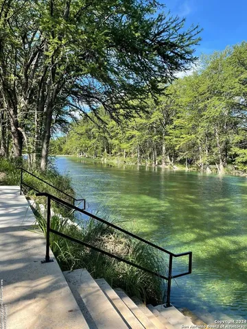 a view of a lake with a bench next to a lake