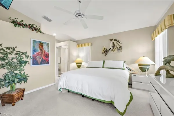 a bedroom with a bed and a painting on the wall