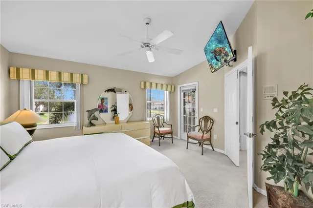 a bedroom with furniture and a large window