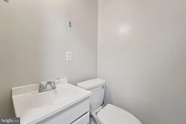 a white toilet sitting next to a white sink