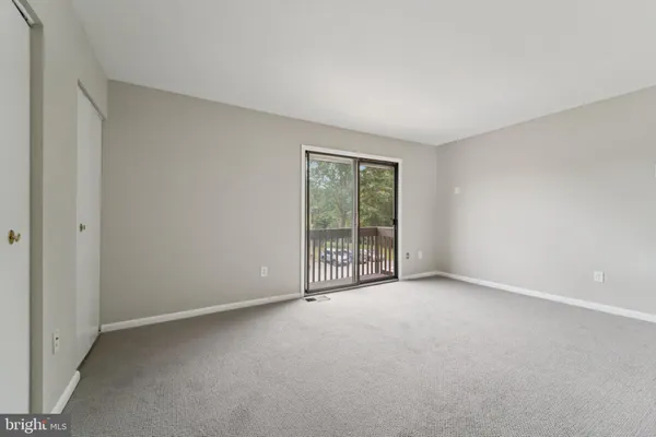 a view of an empty room with glass door