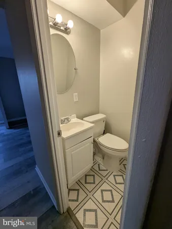 a bathroom with a sink a toilet and a mirror