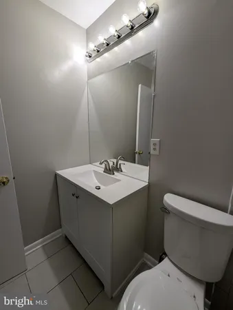 a bathroom with a sink and mirror with toilet