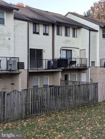 a view of a house with wooden fence