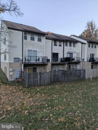 a view of a house with wooden fence