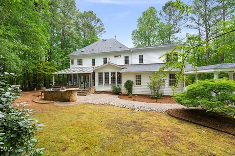 a aerial view of a house with a yard table and chairs