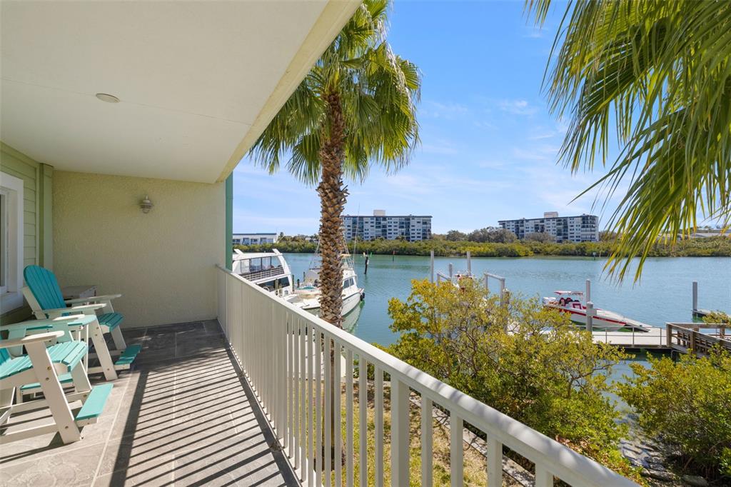 399 2nd Street, Unit 216 Indian Rocks Beach, FL 33785 - Photo 20 of 45 a view of a lake with a table and chairs
