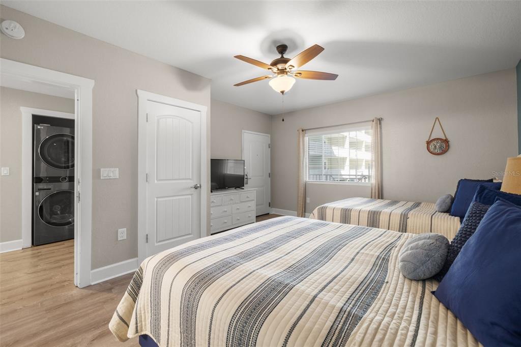 399 2nd Street, Unit 216 Indian Rocks Beach, FL 33785 - Photo 22 of 45 a bedroom with a large bed and a chandelier