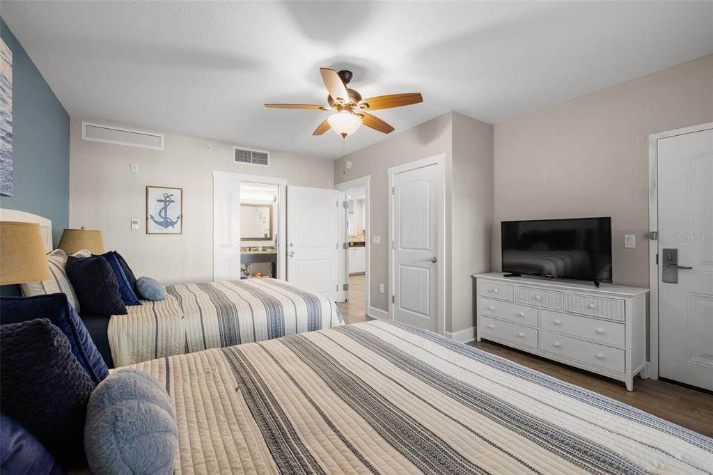 399 2nd Street, Unit 216 Indian Rocks Beach, FL 33785 - Photo 23 of 45 a bedroom with furniture and a flat screen tv