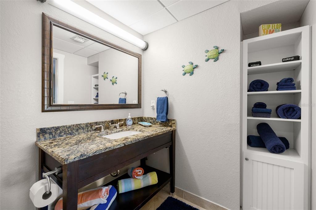 399 2nd Street, Unit 216 Indian Rocks Beach, FL 33785 - Photo 24 of 45 a bathroom with a granite countertop sink and a mirror