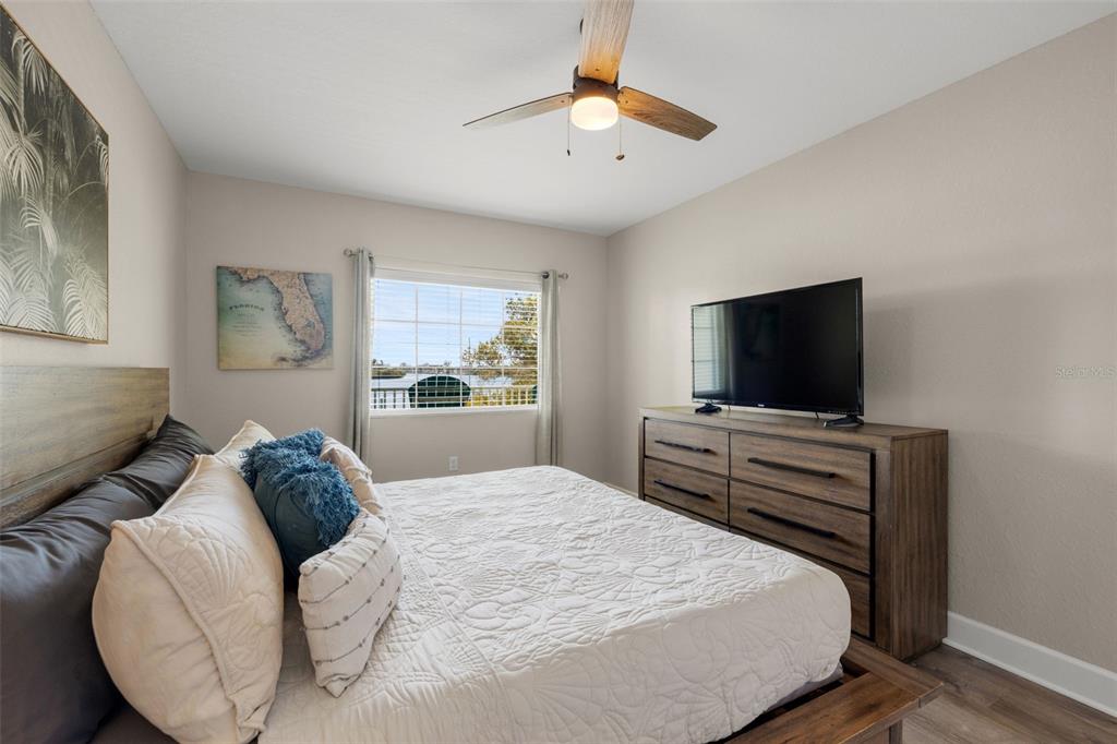 399 2nd Street, Unit 216 Indian Rocks Beach, FL 33785 - Photo 25 of 45 a bedroom with a bed and a flat screen tv