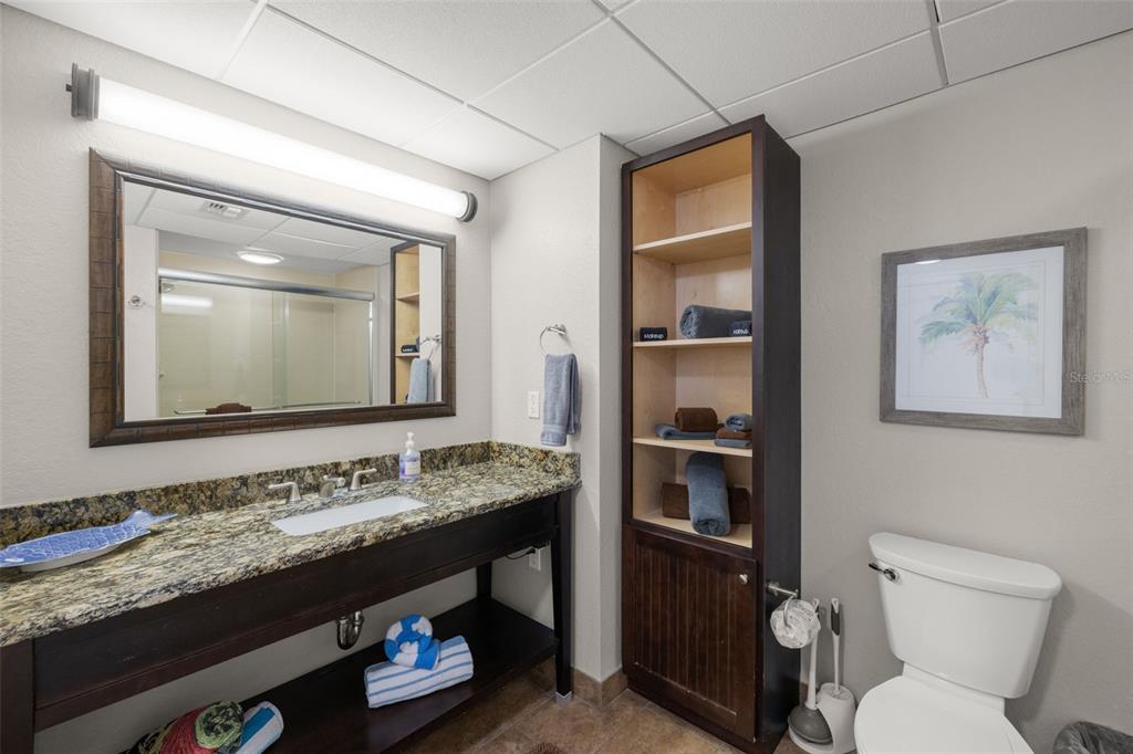 399 2nd Street, Unit 216 Indian Rocks Beach, FL 33785 - Photo 27 of 45 a bathroom with a granite countertop toilet sink and mirror