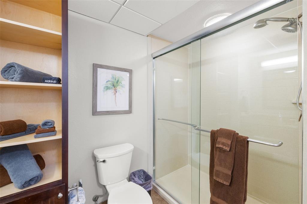 399 2nd Street, Unit 216 Indian Rocks Beach, FL 33785 - Photo 28 of 45 a bathroom with a toilet and a shower curtain