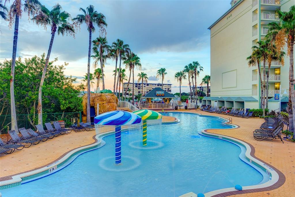 399 2nd Street, Unit 216 Indian Rocks Beach, FL 33785 - Photo 30 of 45 a swimming pool with outdoor seating