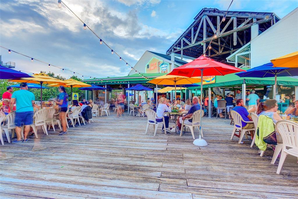 399 2nd Street, Unit 216 Indian Rocks Beach, FL 33785 - Photo 32 of 45 a view of group of people sitting outside of a building