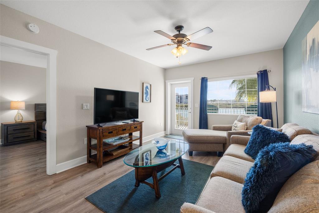 399 2nd Street, Unit 216 Indian Rocks Beach, FL 33785 - Photo 6 of 45 a living room with furniture and a flat screen tv
