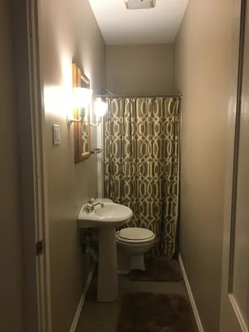 a bathroom with a sink toilet and a mirror