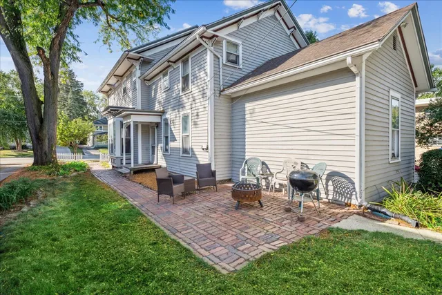 a view of a house with backyard and sitting area