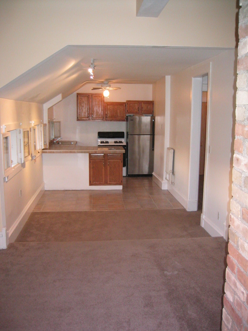 528 East Chicago Street Elgin, IL 60120 - Photo 7 of 15 a room with stainless steel appliances kitchen island granite countertop a refrigerator and a stove top oven
