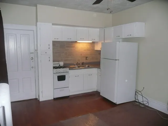 a white refrigerator freezer sitting in a kitchen