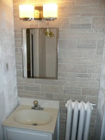 a bathroom with a sink and shower