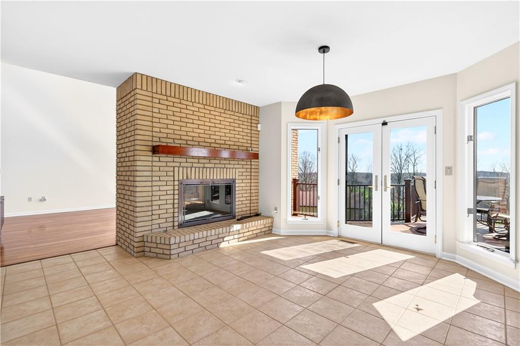 258 Evans Road Zelienople, PA 16063 - Photo 10 of 50 The double sided fireplace creates a statement piece...