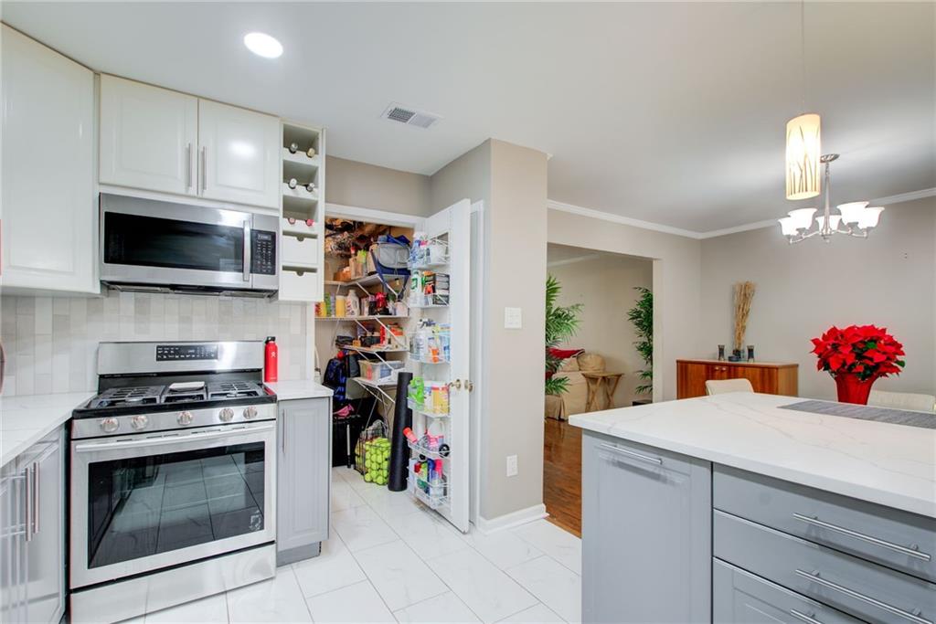 10 Market Square Place Northwest Atlanta, GA 30318 - Photo 13 of 36 a kitchen with a stove and cabinets