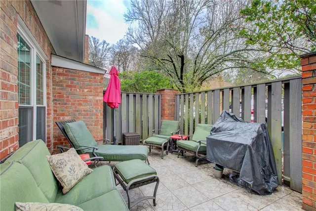 a view of a patio with furniture and a fire pit