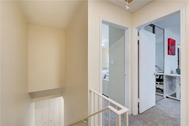 a view of hallway with cabinet and rug