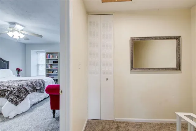 a bedroom with a bed a couch chair and a window