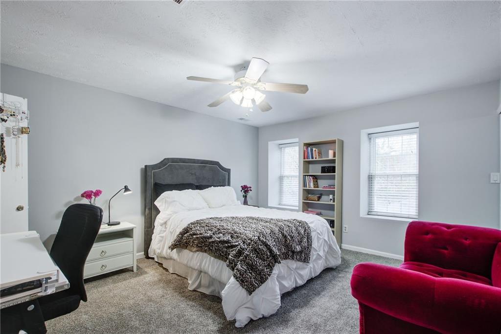10 Market Square Place Northwest Atlanta, GA 30318 - Photo 21 of 36 a bedroom with a bed a couch chair and a window