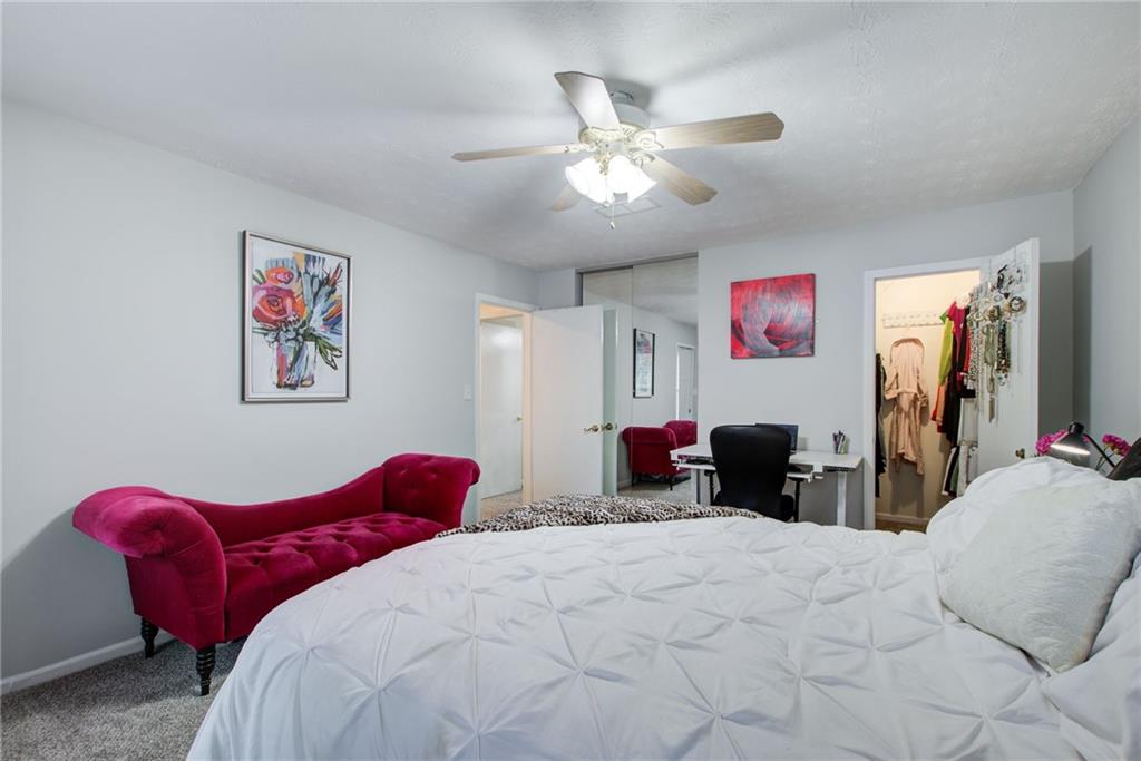 10 Market Square Place Northwest Atlanta, GA 30318 - Photo 22 of 36 a bedroom with a bed and a chandelier