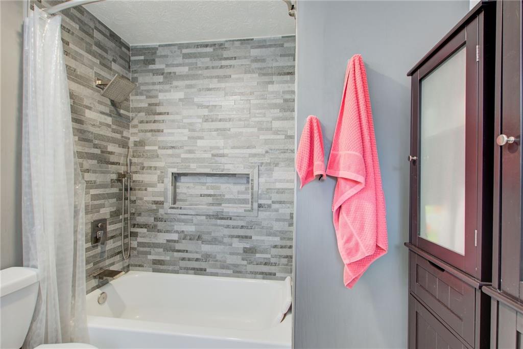 10 Market Square Place Northwest Atlanta, GA 30318 - Photo 25 of 36 a bathroom with a bathtub and a shower
