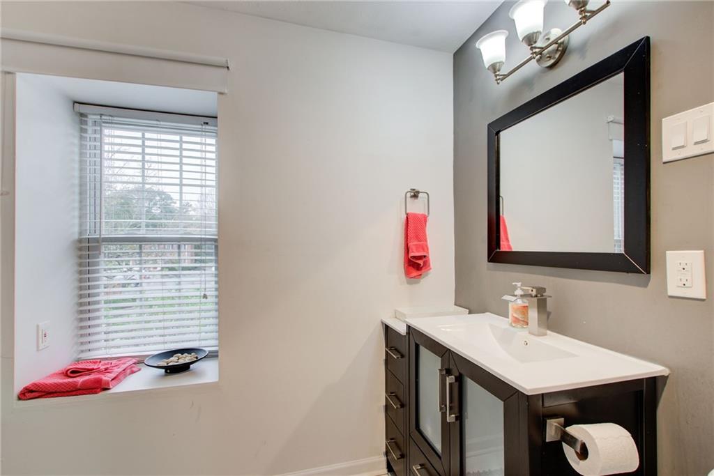 10 Market Square Place Northwest Atlanta, GA 30318 - Photo 26 of 36 a bathroom with a sink vanity and a mirror