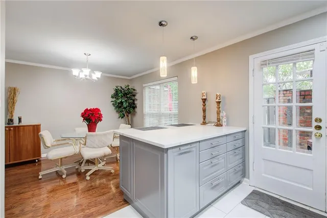 a living room with kitchen island granite countertop furniture and a potted plant