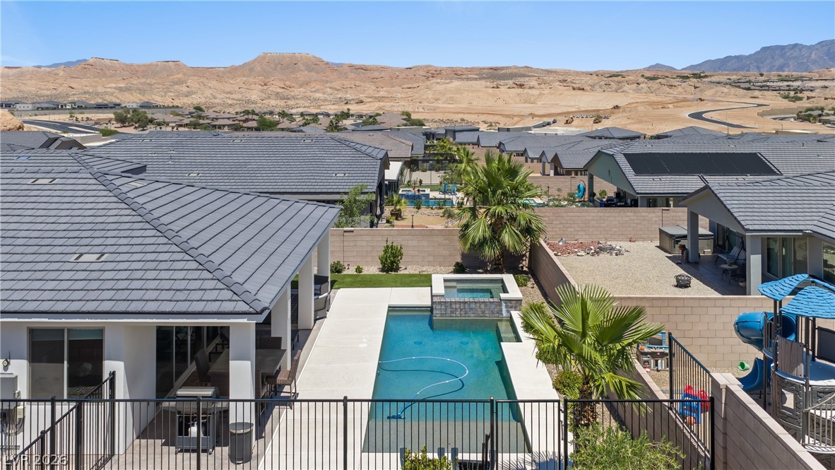 1436 Manassas Ridge Mesquite, NV 89027 - Photo 75 of 77 An inviting pool and spa beckon under desert skies, framed by rugged mountains.