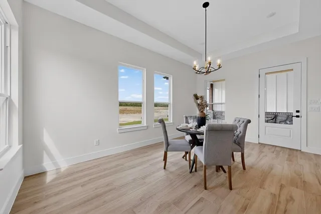 a large kitchen with stainless steel appliances a stove a sink dishwasher and cabinets with wooden floor