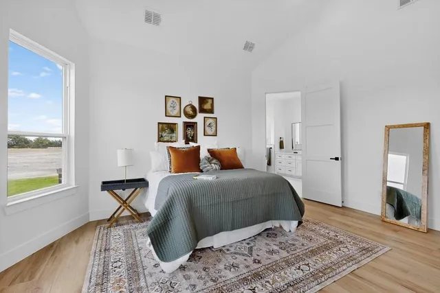 a bedroom with a bed and wooden floor