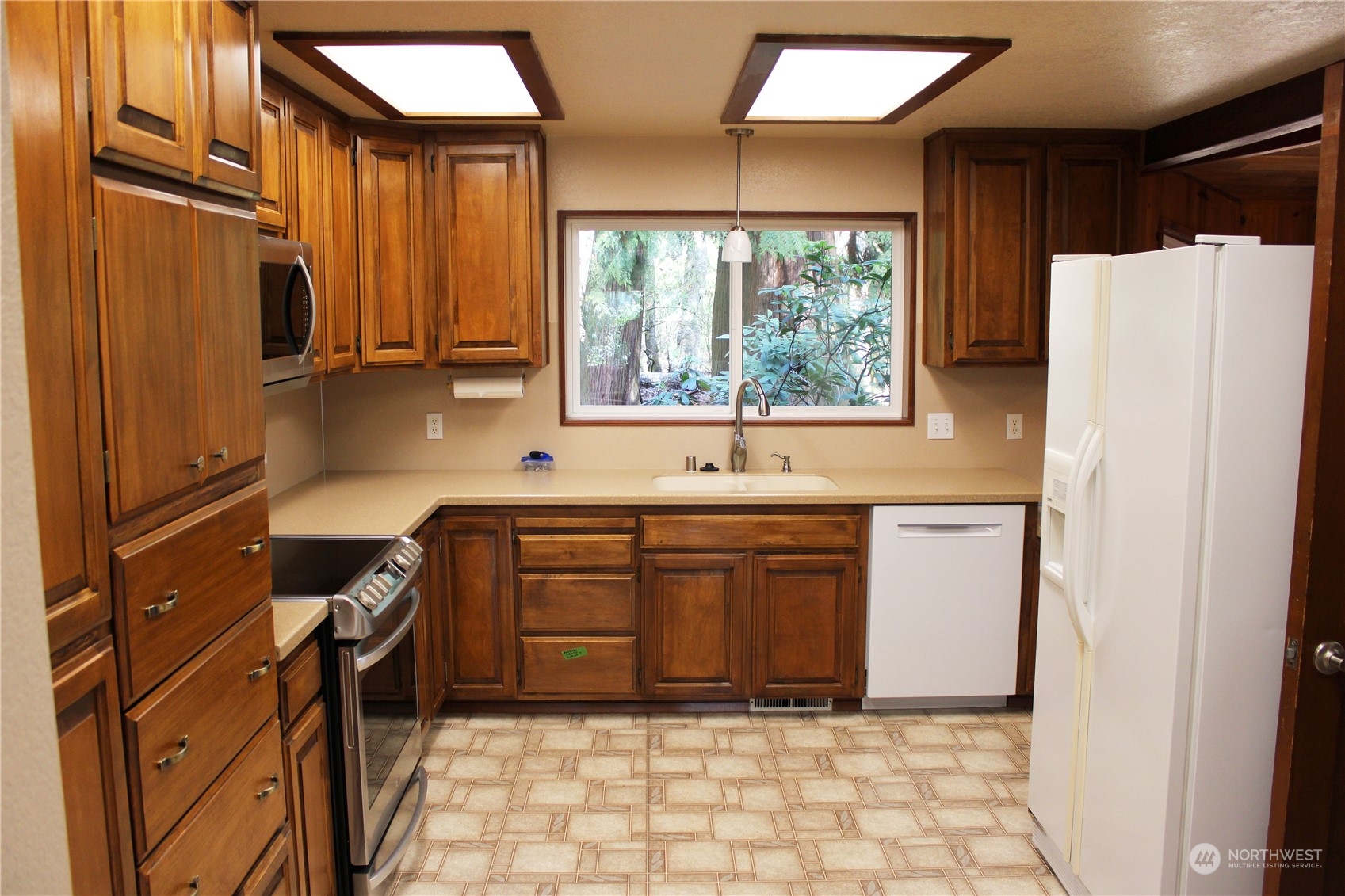 365 Dungeness Meadows Sequim, WA 98382 - Photo 6 of 28 a kitchen with stainless steel appliances granite countertop a refrigerator and a sink