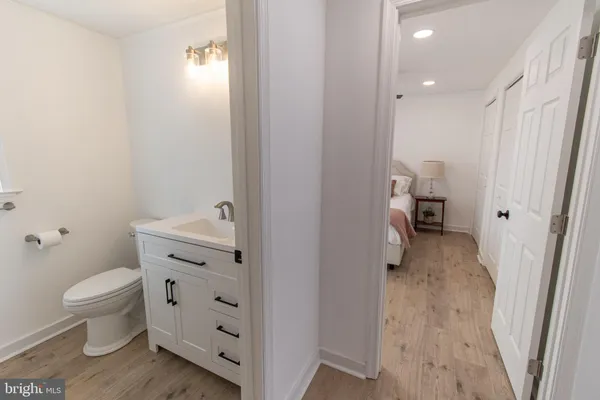 a bathroom with a toilet sink and a mirror