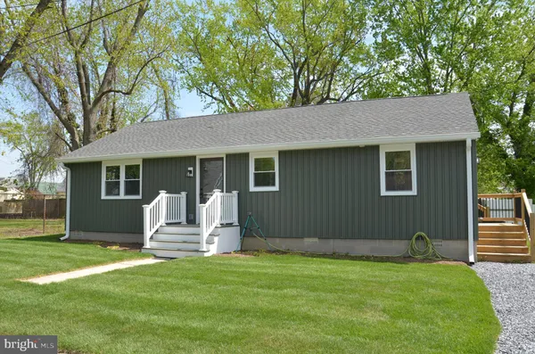 a front view of a house with yard outdoor seating and yard