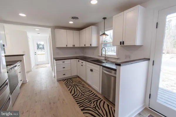 a kitchen with a sink window and cabinets