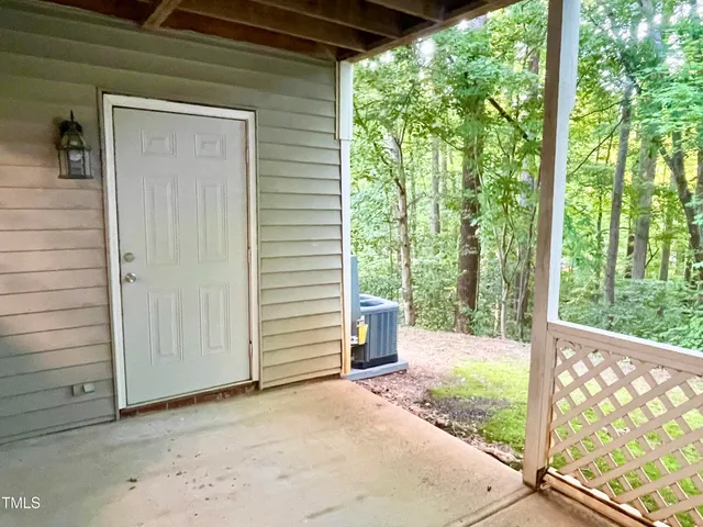 a view of a room with a large window and wooden fence
